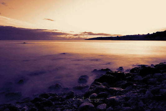 Rocky Beach Against The Sunset - Art Print