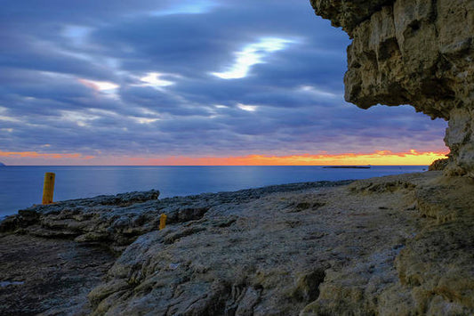 The Big Rock Against The Cloudy Sunset - Art Print